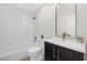 Bathroom boasts a shower and tub combo plus a vanity with dark shaker cabinets at 6961 Emerald Springs Ln, Las Vegas, NV 89113