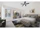 Bedroom with a sliding glass door to backyard pool, plantation shutters and fan with bed at 6961 Emerald Springs Ln, Las Vegas, NV 89113