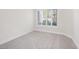 Bedroom with neutral carpet, base trim, and window with shutters at 6961 Emerald Springs Ln, Las Vegas, NV 89113