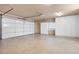 Spacious garage with white storage cabinets and epoxy flooring at 6961 Emerald Springs Ln, Las Vegas, NV 89113