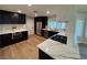 Kitchen with modern dark cabinets, quartz countertops, and stainless steel appliances at 6961 Emerald Springs Ln, Las Vegas, NV 89113