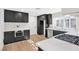 Updated kitchen boasts modern black cabinets, stainless appliances, and quartz countertops at 6961 Emerald Springs Ln, Las Vegas, NV 89113