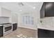 Bright kitchen with stainless steel oven and range and dark lower cabinets at 6961 Emerald Springs Ln, Las Vegas, NV 89113