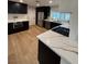 Beautiful kitchen with dark cabinets, stainless appliances, and light wood floors at 6961 Emerald Springs Ln, Las Vegas, NV 89113