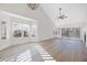Spacious living area with vaulted ceilings, large windows, and plantation shutters, offering natural light at 6961 Emerald Springs Ln, Las Vegas, NV 89113
