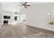 Bright, open living room featuring wood flooring, a vaulted ceiling, and seamless flow to the updated kitchen at 6961 Emerald Springs Ln, Las Vegas, NV 89113