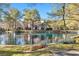 Picturesque view of a tranquil pond surrounded by trees and well-maintained lawns at 6961 Emerald Springs Ln, Las Vegas, NV 89113