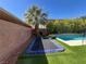 Spacious backyard featuring in-ground trampoline, beautiful palm tree, and synthetic grass at 7109 Rancho De Taos, Las Vegas, NV 89130