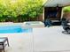 Beautiful backyard featuring a swimming pool, hot tub, covered patio, and outdoor seating area at 7109 Rancho De Taos, Las Vegas, NV 89130