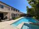 Backyard view with a pool and hot tub, patio seating, and lush greenery, ideal for outdoor entertaining at 7109 Rancho De Taos, Las Vegas, NV 89130