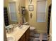 Well-lit bathroom featuring a modern vanity, toilet, and shower with black accents and decor at 7109 Rancho De Taos, Las Vegas, NV 89130
