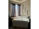 Close up of a primary bathroom featuring a corner soaking tub and natural light at 7109 Rancho De Taos, Las Vegas, NV 89130