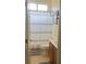 Bathroom showcasing a framed shower curtain, simple cabinets, and tiled flooring at 7109 Rancho De Taos, Las Vegas, NV 89130