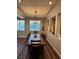 Dining room with a long wooden table, modern light fixture, and decorative recessed shelving at 7109 Rancho De Taos, Las Vegas, NV 89130