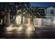 Beautiful two-story home with a three-car garage framed by mature palm trees at dusk at 7109 Rancho De Taos, Las Vegas, NV 89130