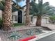 Beautiful home featuring an arched entry door, mature palm trees, and a three car garage at 7109 Rancho De Taos, Las Vegas, NV 89130
