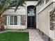 Charming front entrance featuring a secure metal gate and manicured front yard with stone accents at 7109 Rancho De Taos, Las Vegas, NV 89130