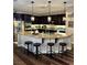 Modern kitchen featuring dark cabinets, stainless steel appliances, and a curved breakfast bar with seating at 7109 Rancho De Taos, Las Vegas, NV 89130
