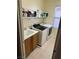 Functional laundry room featuring a sink, a modern washer and dryer, and built-in shelving at 7109 Rancho De Taos, Las Vegas, NV 89130