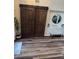 Cozy living area with hardwood floors, built in bench seating, and a large sliding barn door at 7109 Rancho De Taos, Las Vegas, NV 89130