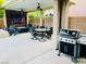 The covered patio area features a built-in grill, dining table, and tv perfect for entertaining at 7109 Rancho De Taos, Las Vegas, NV 89130