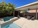 Inviting covered patio with ceiling fans, hot tub, outdoor dining area, and TV at 7109 Rancho De Taos, Las Vegas, NV 89130