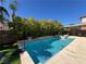 Sparkling pool with lush green landscaping and a patio area, creating a perfect backyard retreat at 7109 Rancho De Taos, Las Vegas, NV 89130