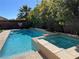 Beautiful pool and jacuzzi with basketball hoop and manicured greenery around perimeter at 7109 Rancho De Taos, Las Vegas, NV 89130