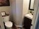 Cozy half bathroom with modern fixtures, fun decor, and hardwood floors at 7109 Rancho De Taos, Las Vegas, NV 89130