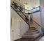 Elegant staircase with carpeted steps and wrought iron railing leading to a second floor loft at 7109 Rancho De Taos, Las Vegas, NV 89130