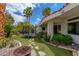 Landscaped backyard featuring artificial grass, a trampoline, and lush greenery at 72 Innisbrook Ave, Las Vegas, NV 89113