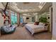 Main bedroom features a mirrored wall, a sitting area, and a king bed at 72 Innisbrook Ave, Las Vegas, NV 89113