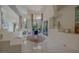 Bright dining room with tile floors, a modern chandelier, and views of the manicured yard at 72 Innisbrook Ave, Las Vegas, NV 89113