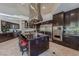 Elegant kitchen featuring an island with seating, stainless steel appliances, and sleek dark wood cabinets at 72 Innisbrook Ave, Las Vegas, NV 89113