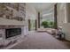 Elegant living room with a fireplace, large windows, and comfortable seating, ideal for relaxation at 72 Innisbrook Ave, Las Vegas, NV 89113