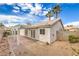 An exterior view shows the house's backyard featuring a covered patio area and manicured landscaping at 7413 Red Eagle St, Las Vegas, NV 89131