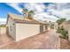 Exterior shot of the house's backyard featuring a covered patio area and manicured landscaping at 7413 Red Eagle St, Las Vegas, NV 89131