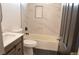 Well-lit bathroom with a modern vanity, white countertop and tub-shower combo with tile surround at 7413 Red Eagle St, Las Vegas, NV 89131