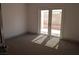Clean bedroom with carpet and double doors to the patio at 7413 Red Eagle St, Las Vegas, NV 89131