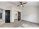 Bedroom features carpet, a ceiling fan, closet, and an adjacent room at 7413 Red Eagle St, Las Vegas, NV 89131