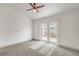 Bedroom features carpet, a ceiling fan, and door that leads to a private patio at 7413 Red Eagle St, Las Vegas, NV 89131