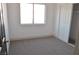 Bright bedroom with neutral carpet, white walls and closet at 7413 Red Eagle St, Las Vegas, NV 89131