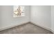 This bedroom features neutral carpeting, a window, and white walls at 7413 Red Eagle St, Las Vegas, NV 89131