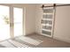 Bedroom featuring glass patio doors and a sliding barn door at 7413 Red Eagle St, Las Vegas, NV 89131