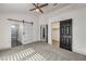 Bedroom features carpet, a ceiling fan, closet, and an adjacent bathroom at 7413 Red Eagle St, Las Vegas, NV 89131