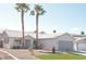 Inviting single-story home featuring desert landscaping, palm trees, and a two-car garage at 7413 Red Eagle St, Las Vegas, NV 89131