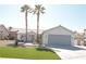 Inviting single-story home featuring desert landscaping, palm trees, and a two-car garage at 7413 Red Eagle St, Las Vegas, NV 89131