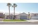 Single-story home featuring desert landscaping, palm trees, and a two-car garage at 7413 Red Eagle St, Las Vegas, NV 89131