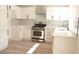 Modern kitchen with stainless steel appliances, white cabinets, and light countertops at 7413 Red Eagle St, Las Vegas, NV 89131