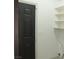 Laundry room featuring a black door and convenient shelving units at 7413 Red Eagle St, Las Vegas, NV 89131